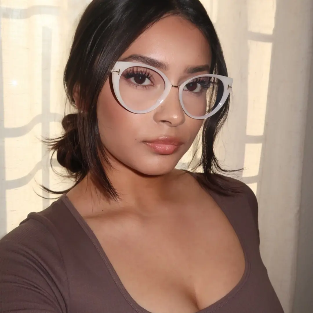 Three-quarter view of female wearing white cat eye eyeglasses, neutral expression, CR0112402