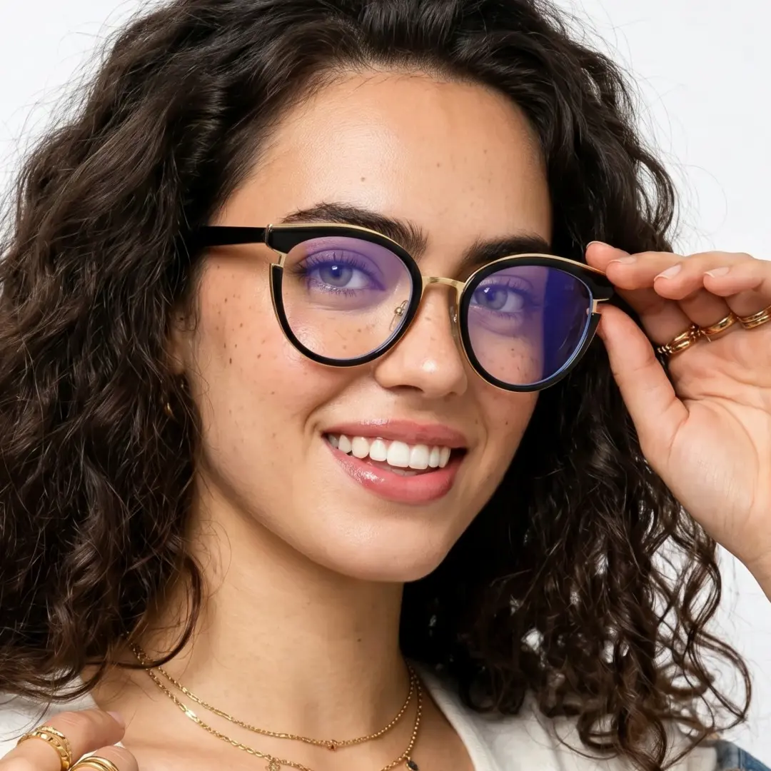 Slightly angled view of female wearing black cat eye eyeglasses, adjusting glasses, smiling, CR0112404
