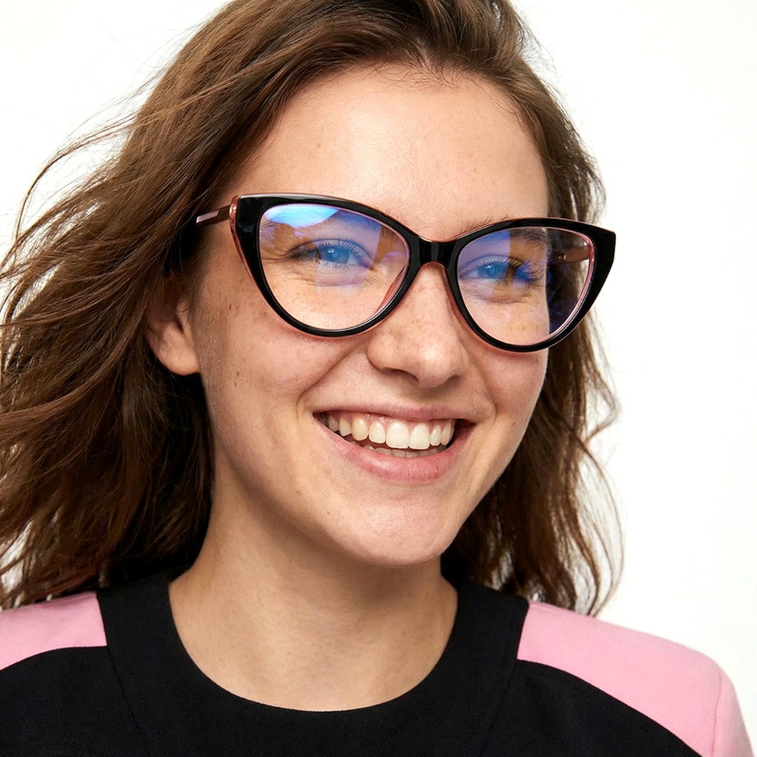 Slightly angled view of female wearing black cat eye eyeglasses, smiling, CR0112408