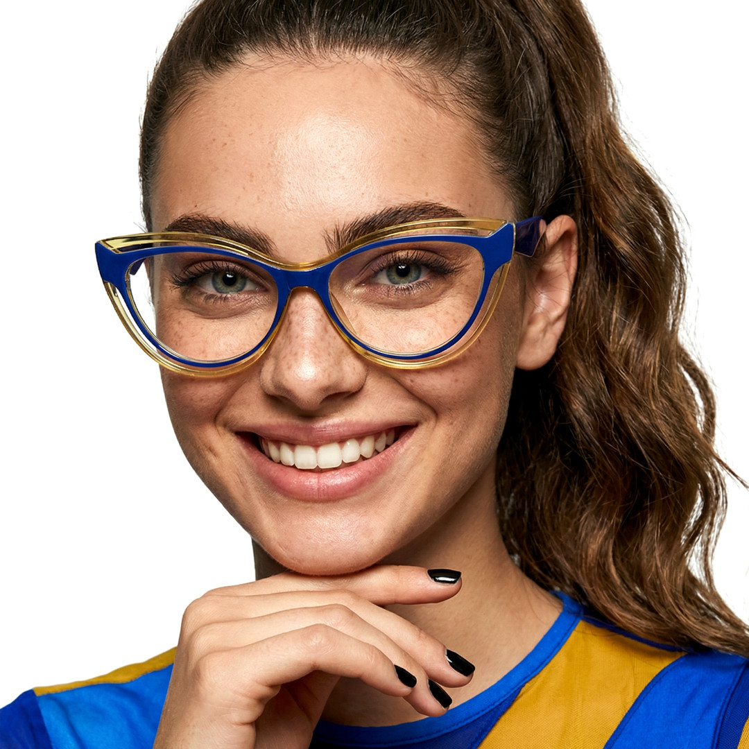 Front view of female wearing vintage blue cat eye eyeglasses, resting chin on hand, smiling, CR0132408