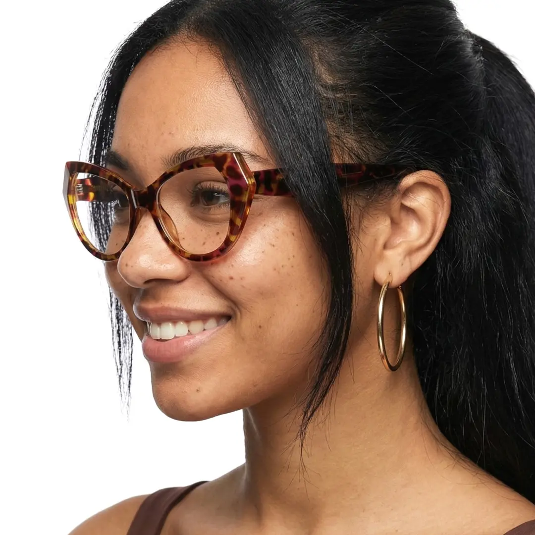 Three-quarter view of female wearing vintage tortoise cat eye eyeglasses, smiling, CR0132411