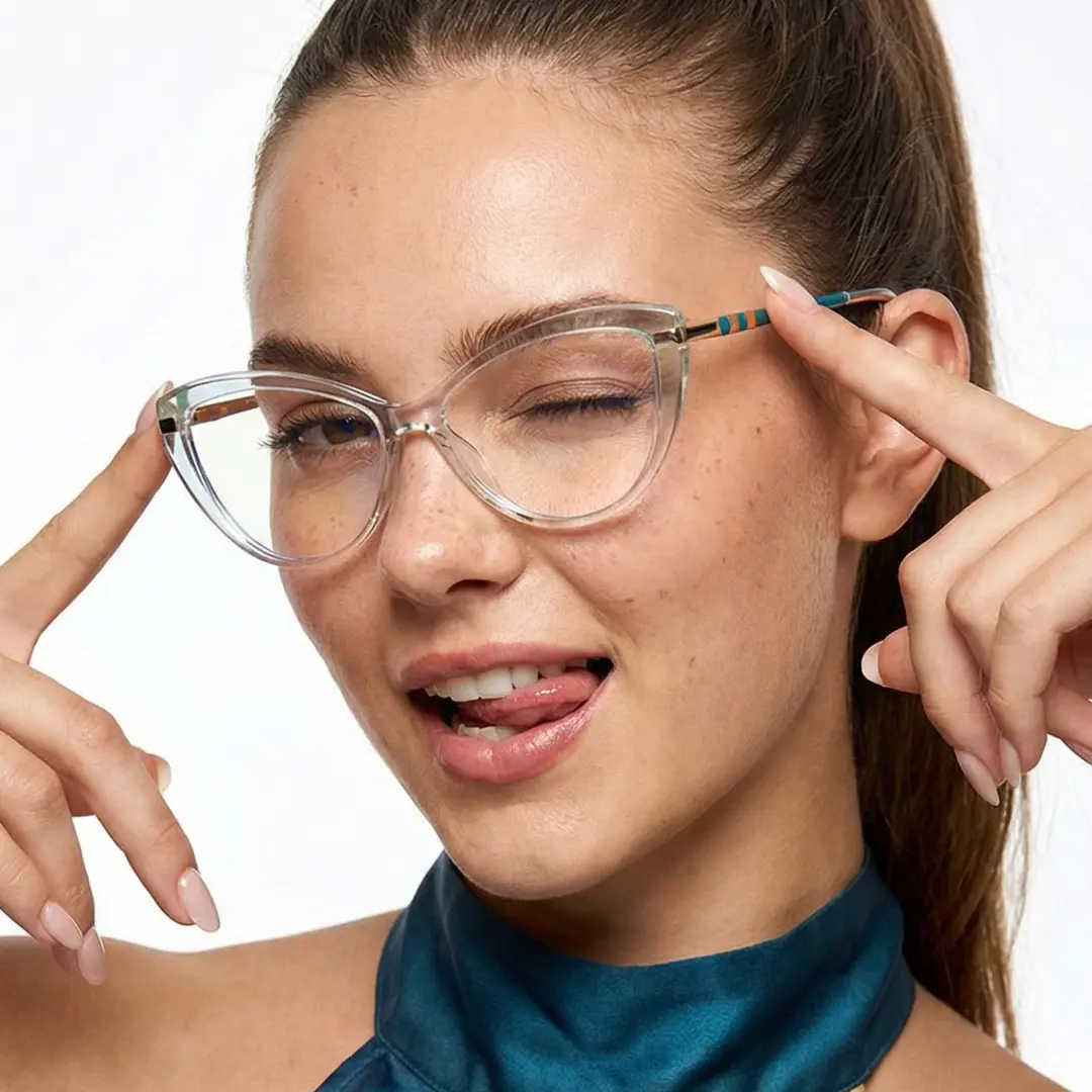 Three-quarter view of female wearing clear cat eye eyeglasses, touching frame, smiling, CR0142309