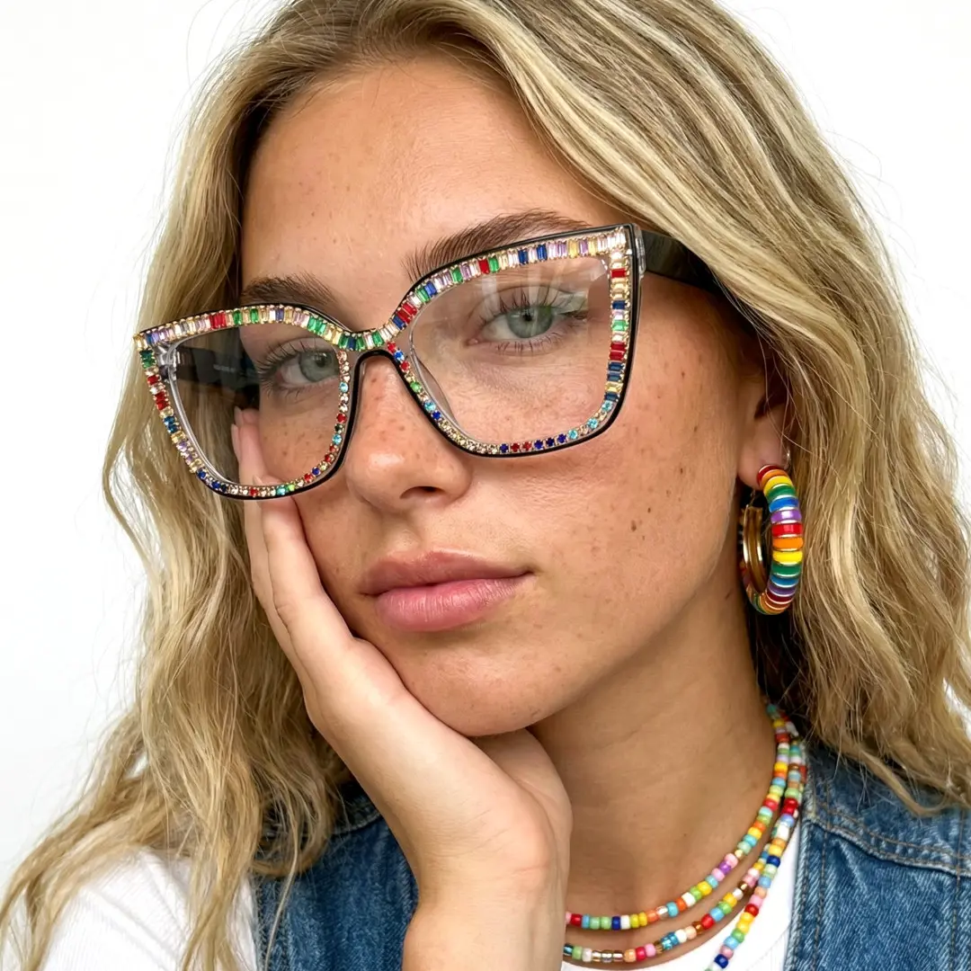 Face close-up view of female wearing multicolor cat eye eyeglasses, hand near face, relaxed expression, CR0142401
