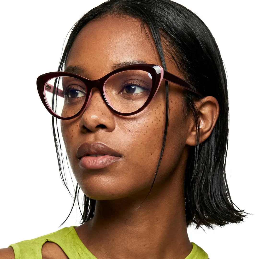 Looking away view of female wearing pink cat eye eyeglasses, neutral expression, CR0142502