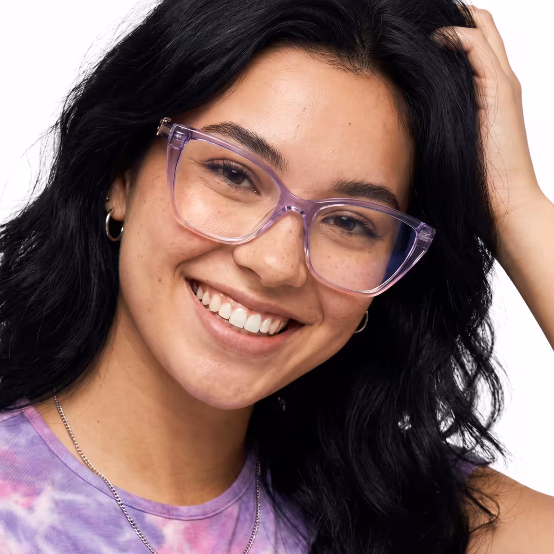 Female wearing purple cat eye tr90 eyeglasses, smiling while hand in hair. SPU: CR0162605