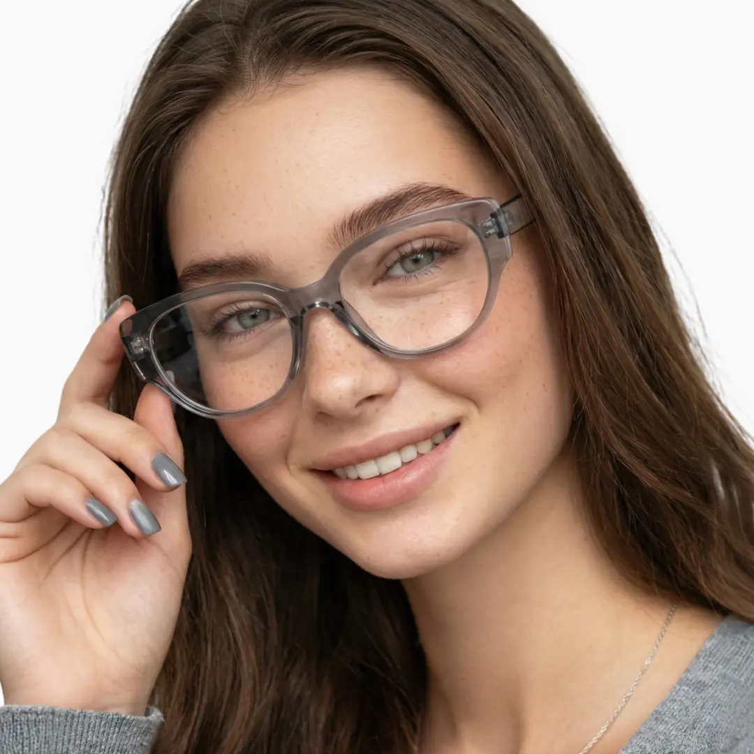 Front view of female wearing grey cat eye eyeglasses, touching frame, natural smile, CR0172302