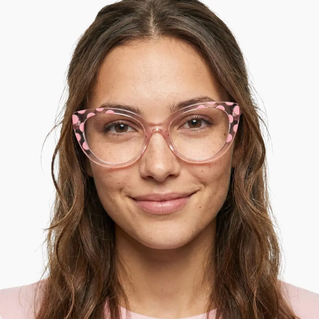 Front view of female wearing pink cat eye eyeglasses, soft smile, CR0172411