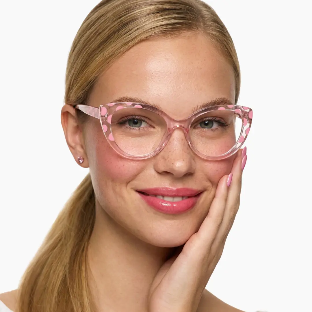 Front view of female wearing pink cat eye eyeglasses, hand near face, natural smile, CR0172411