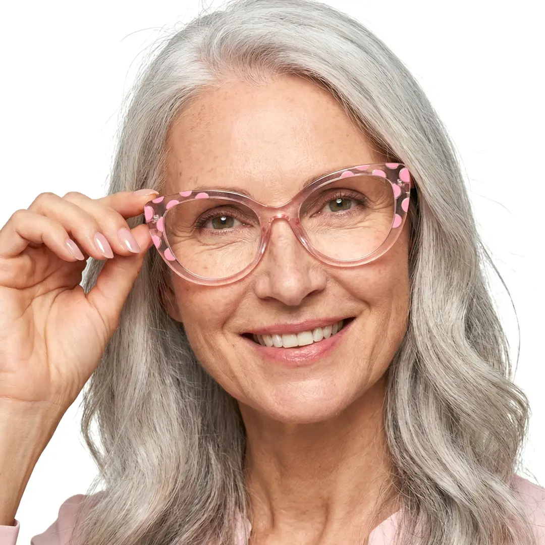 Front view of female wearing pink cat eye eyeglasses, touching frame, friendly smile, CR0172411