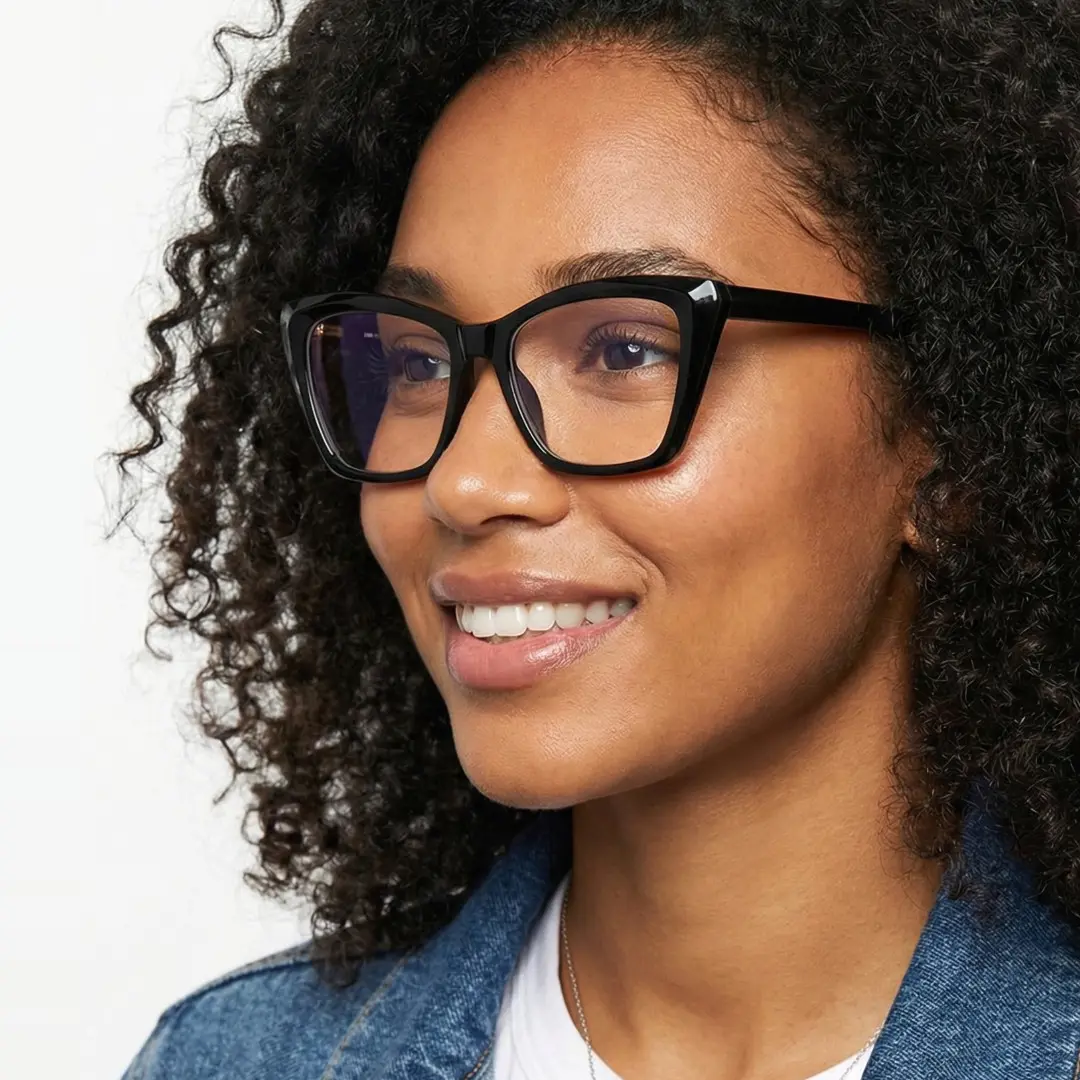 Three-quarter view of female wearing black cat eye eyeglasses, friendly smile, CR0212502