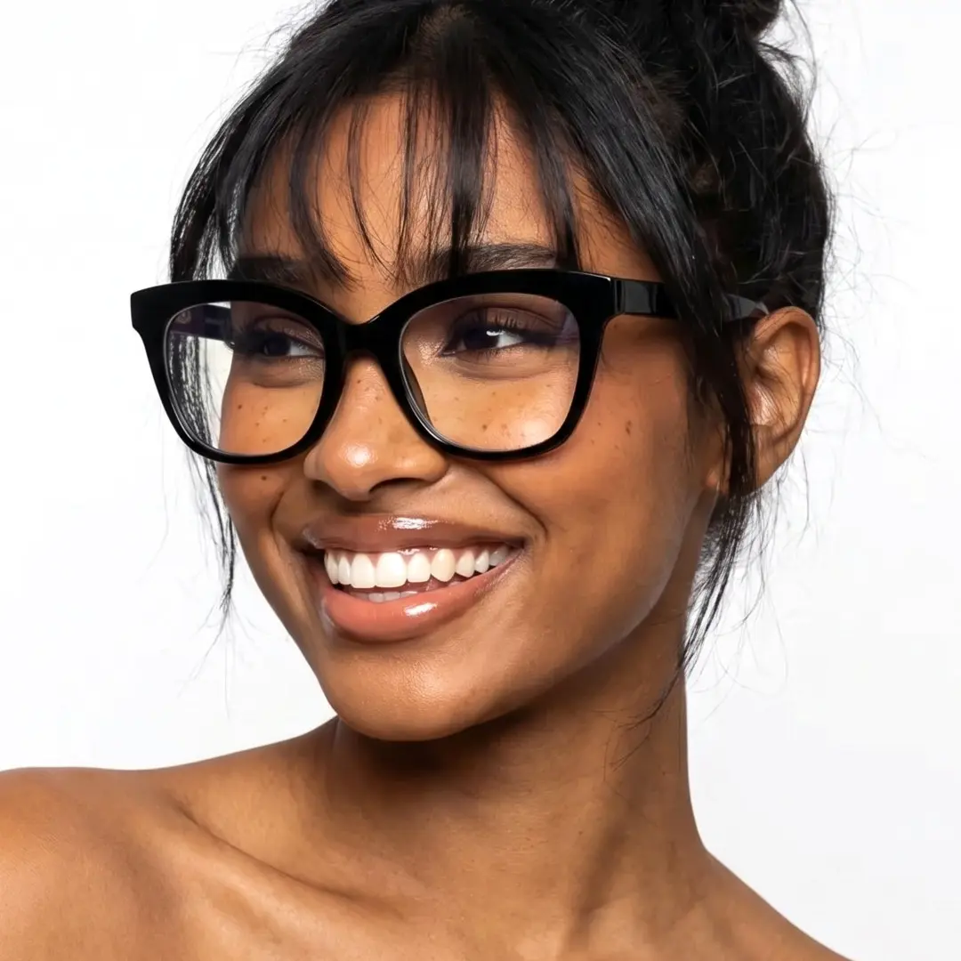 Three-quarter view of female wearing black cat eye eyeglasses, smiling, CR0272302