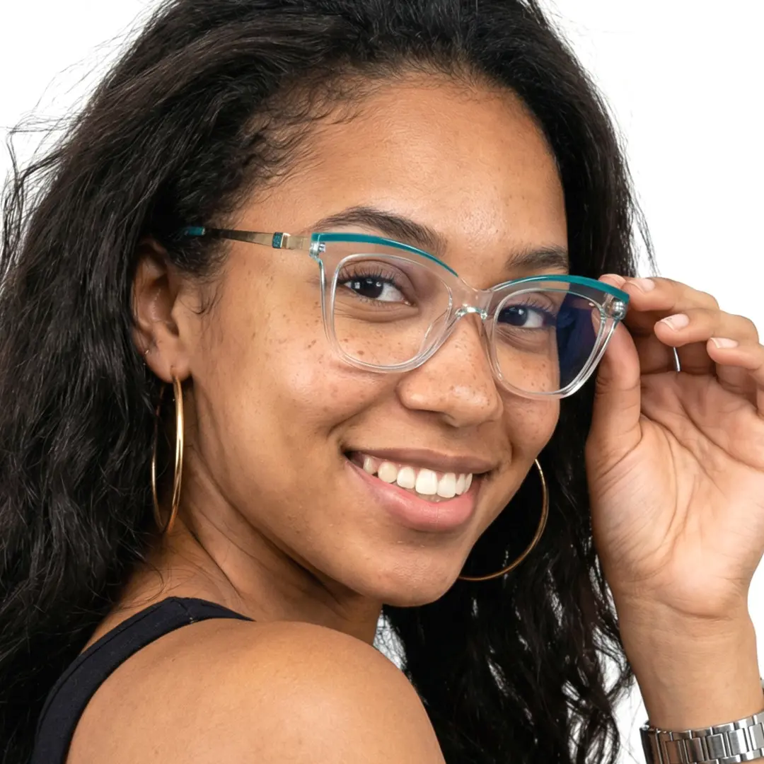 Over-the-shoulder view of female wearing clear cat eye eyeglasses, holding glasses, soft smile, CR0302208