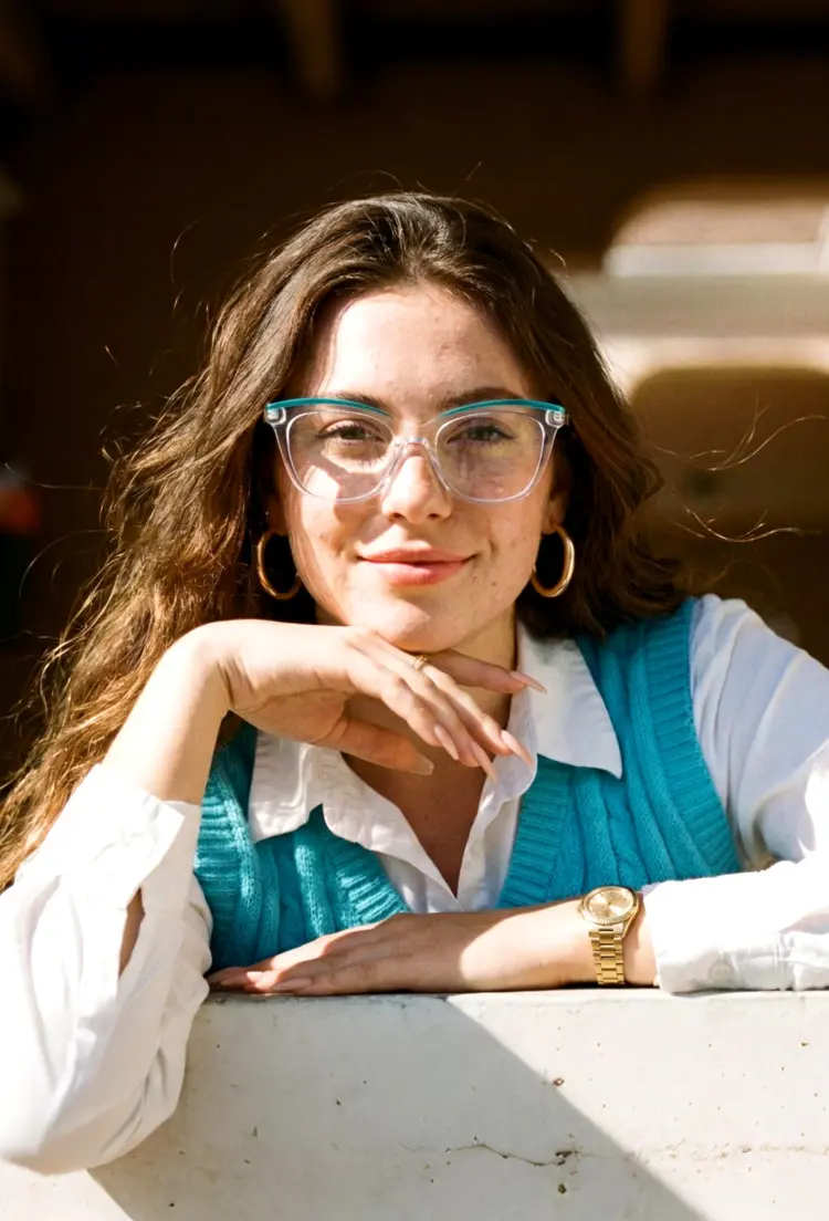 Female model wearing casual clear cat eye tr90 eyeglasses outdoors in natural sunlight. SPU: CR0302208