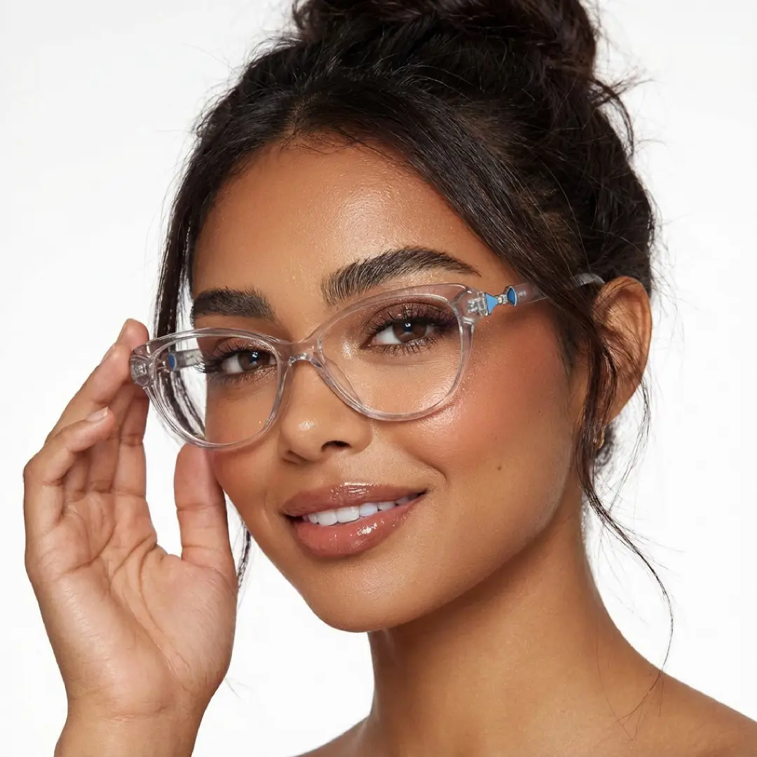 Face close-up view of female wearing grey cat eye eyeglasses, holding glasses, natural smile, CR0302509
