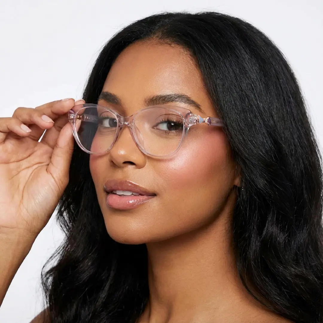 Three-quarter view of female wearing purple cat eye eyeglasses, touching frame, natural expression, CR0302509