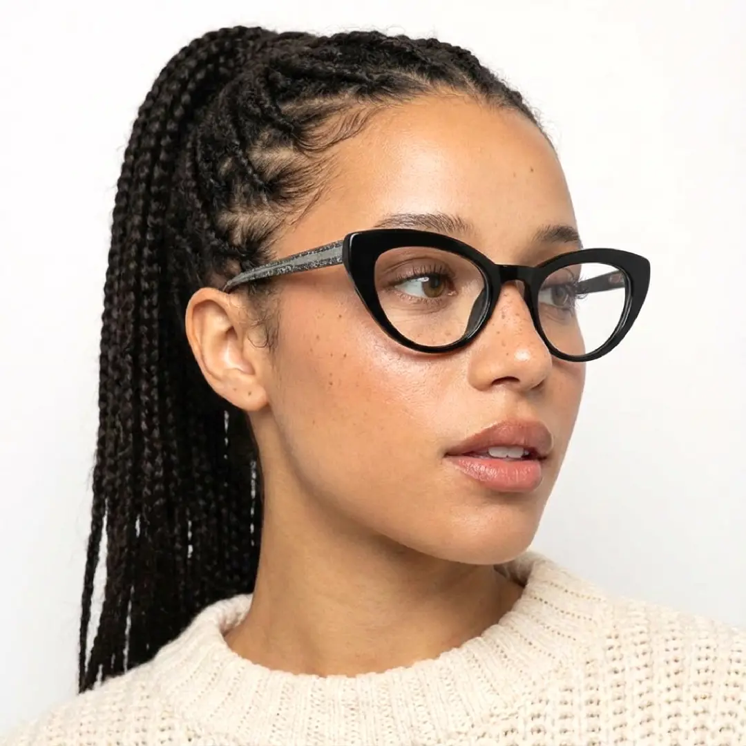 Face close-up view of female wearing black cat eye eyeglasses, neutral expression, CR0312408