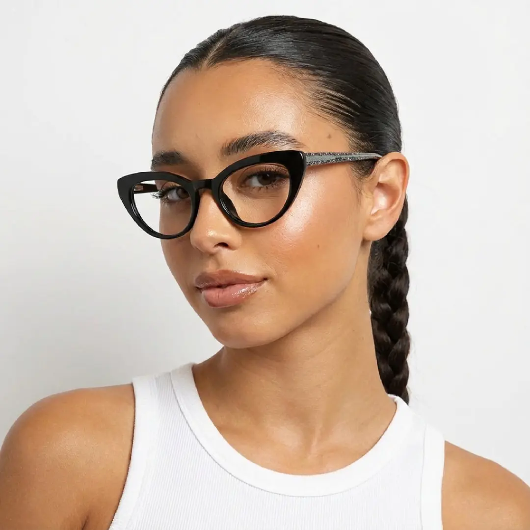 Looking away view of female wearing black cat eye eyeglasses, soft smile, CR0312408