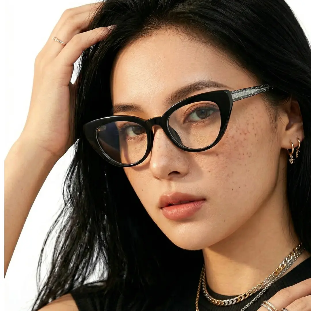 Profile view of female wearing black cat eye eyeglasses, hand in hair, neutral expression, CR0312408