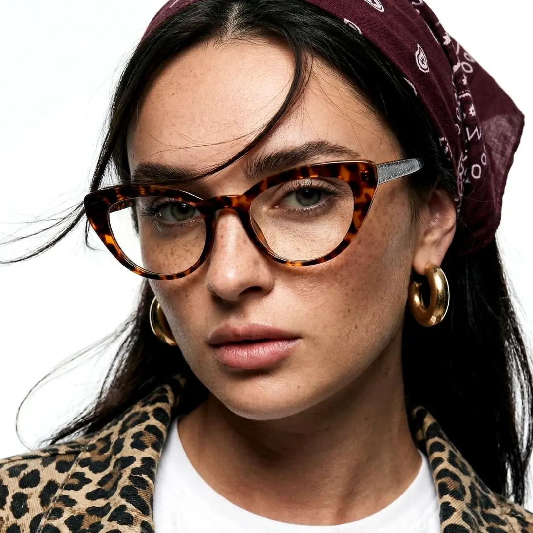 Slightly angled view of female wearing tortoise cat eye eyeglasses, neutral expression, CR0312408