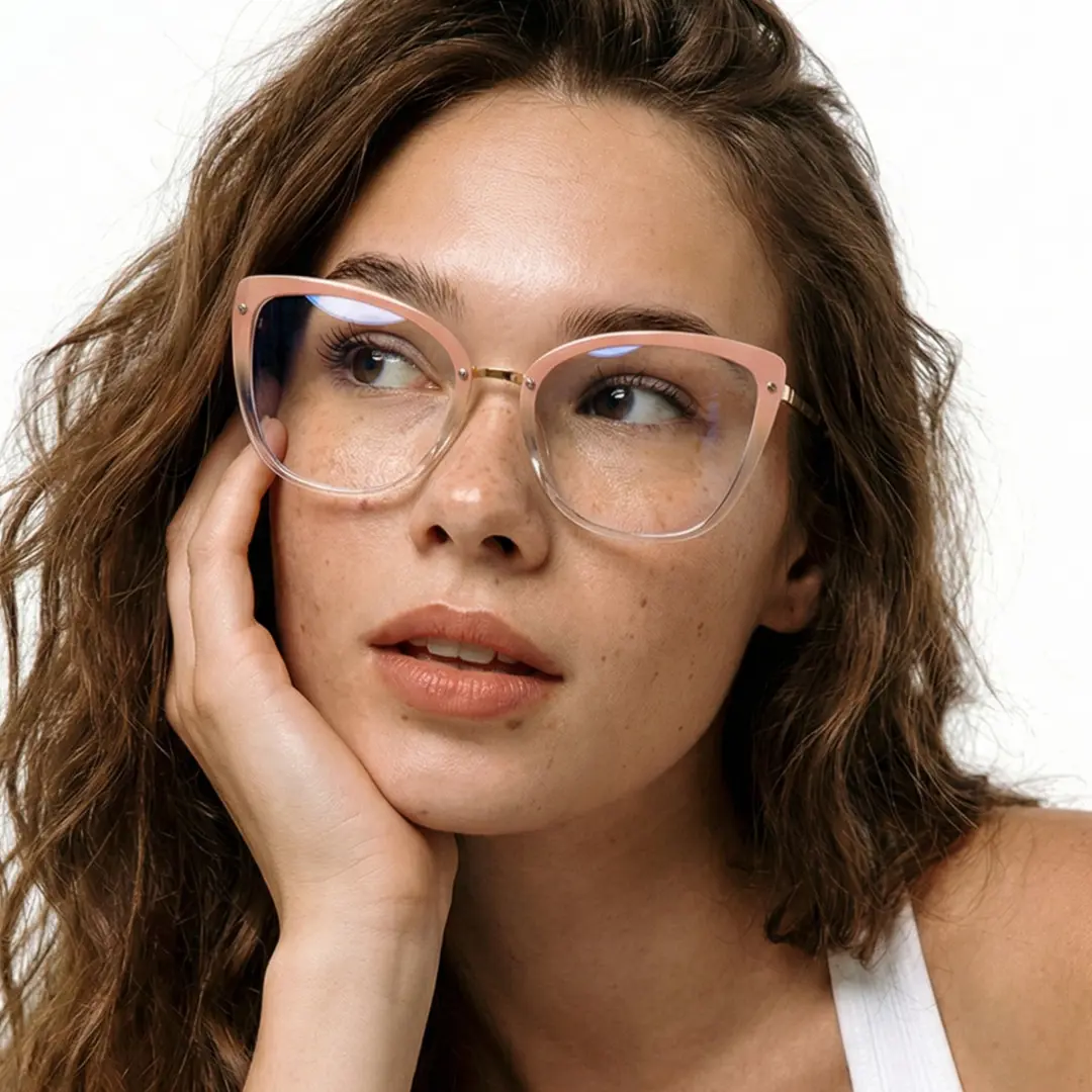 Front view of female wearing gold cat eye eyeglasses, resting chin on hand, natural smile, CR0342302