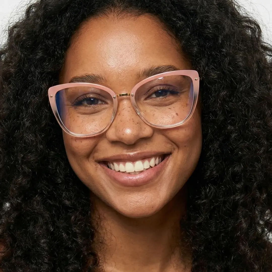Front view of female wearing gold cat eye eyeglasses, smiling, CR0342302