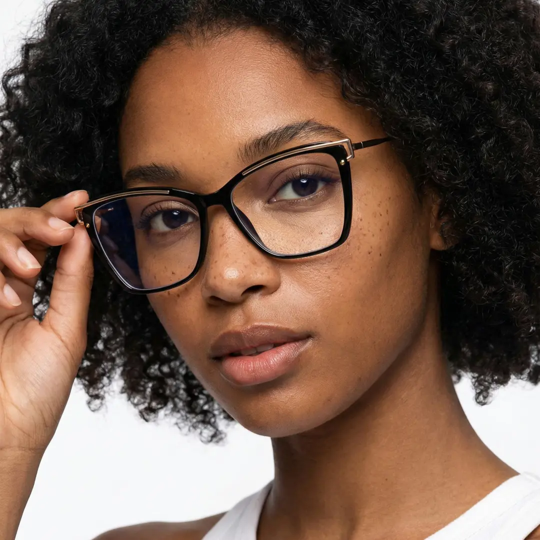 Front view of female wearing black cat eye eyeglasses, touching frame, calm expression, CR0352503