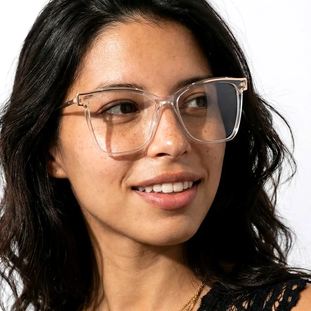 Three-quarter view of female wearing clear cat eye eyeglasses, natural smile, CR0352503