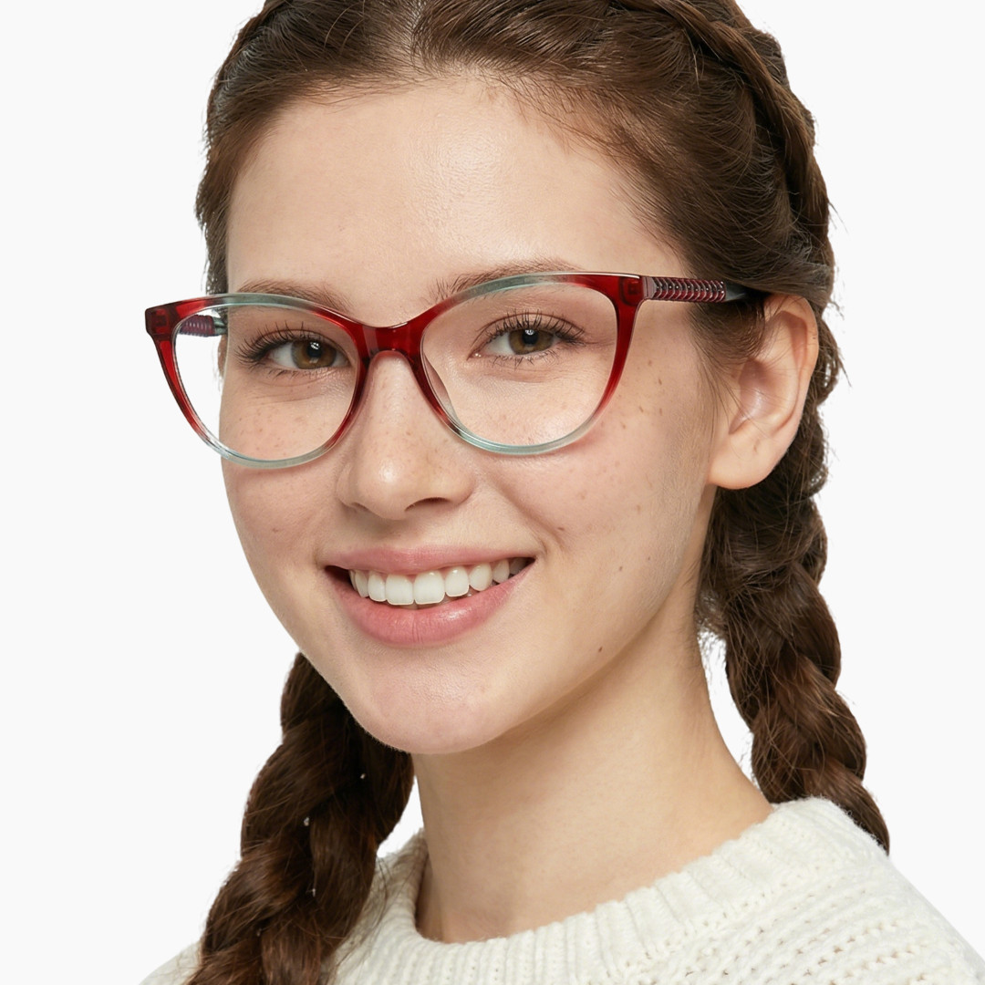 Front view of female wearing red cat eye eyeglasses, smiling, CR0372302