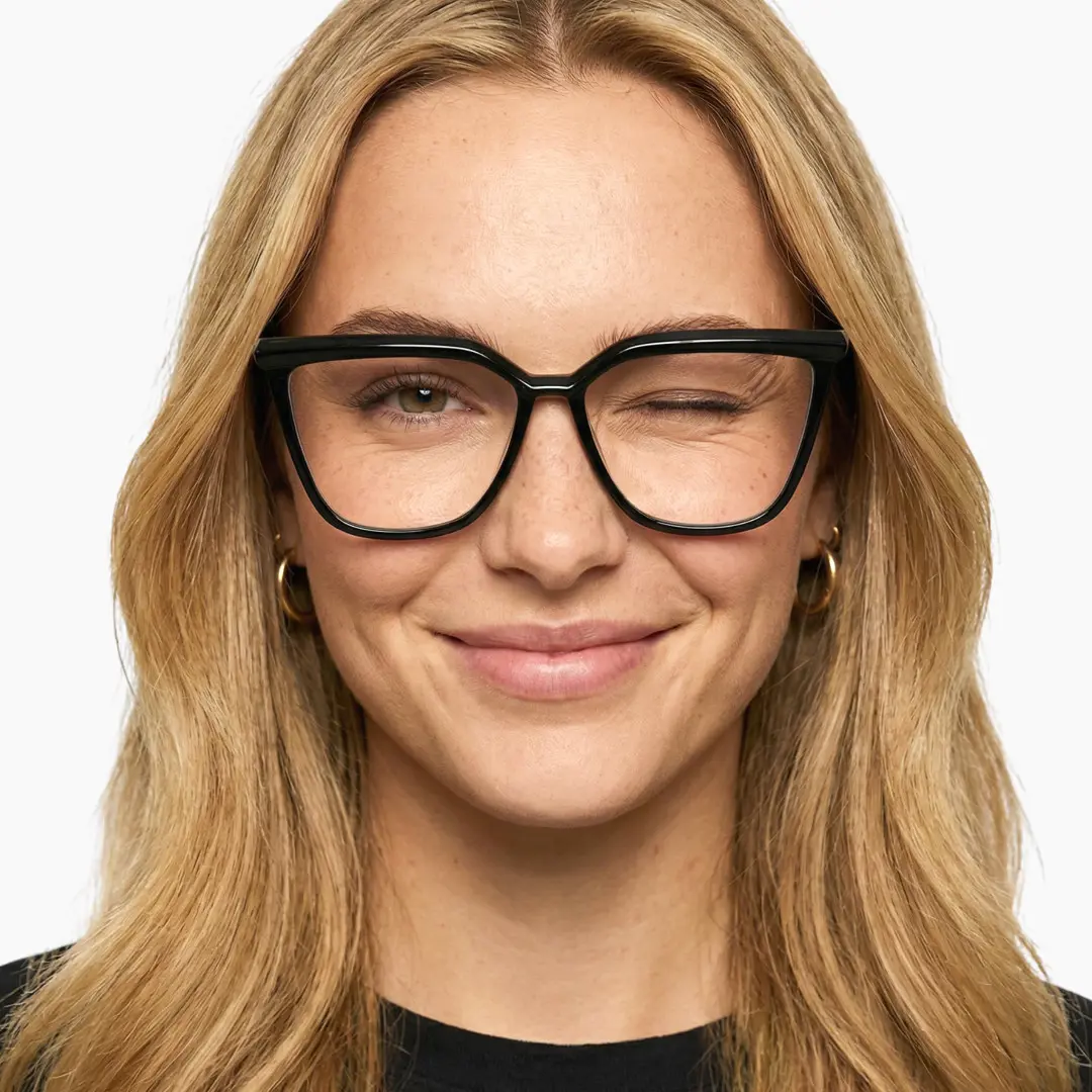 Front view of female wearing black cat eye eyeglasses, winking, natural smile, CR0442302