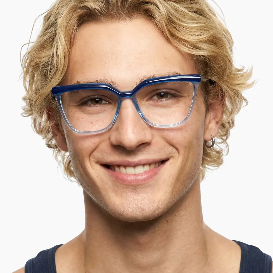 Front view of male wearing blue cat eye eyeglasses, smiling, CR0442302
