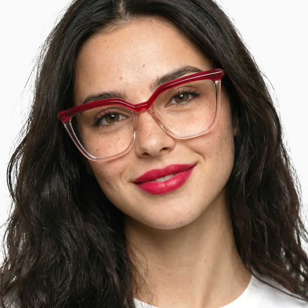 Front view of female wearing red cat eye eyeglasses, smiling, CR0442302