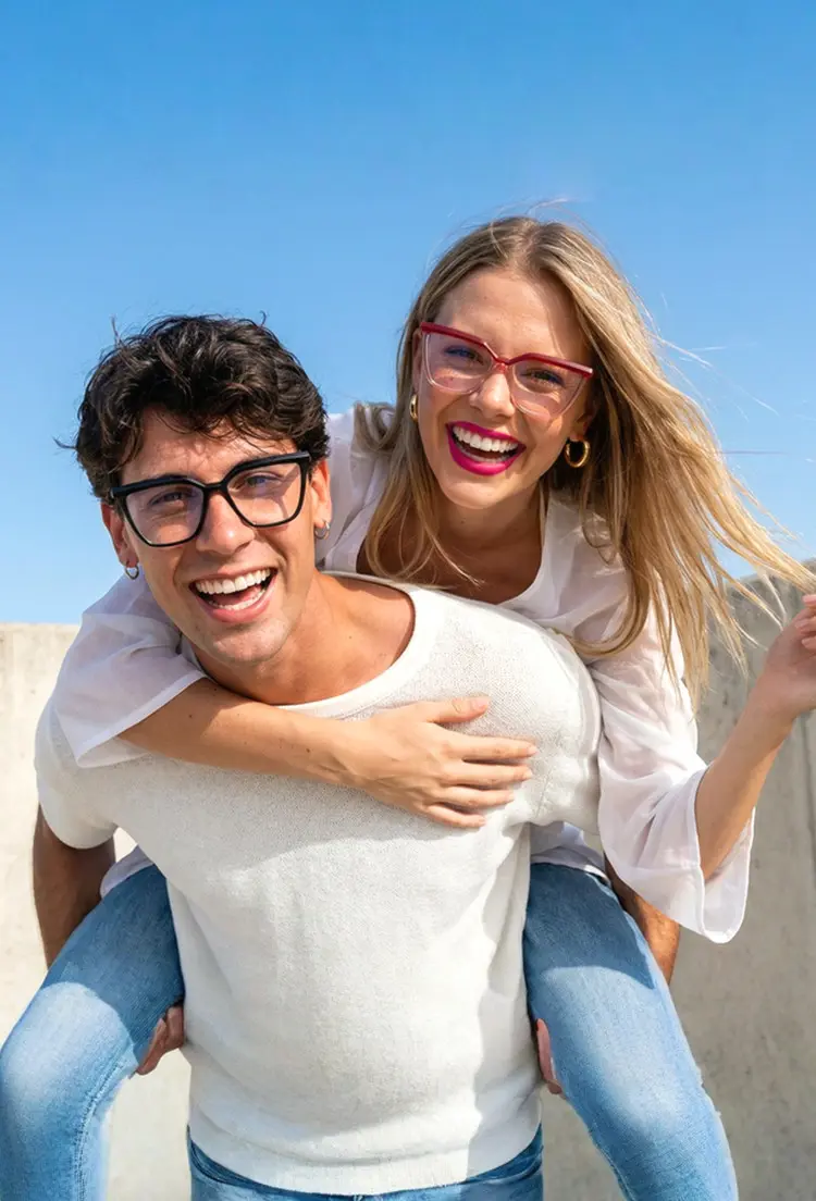 Couple models wearing everyday black and red cat eye tr90 eyeglasses outdoors under a blue sky. SPU: CR0442302