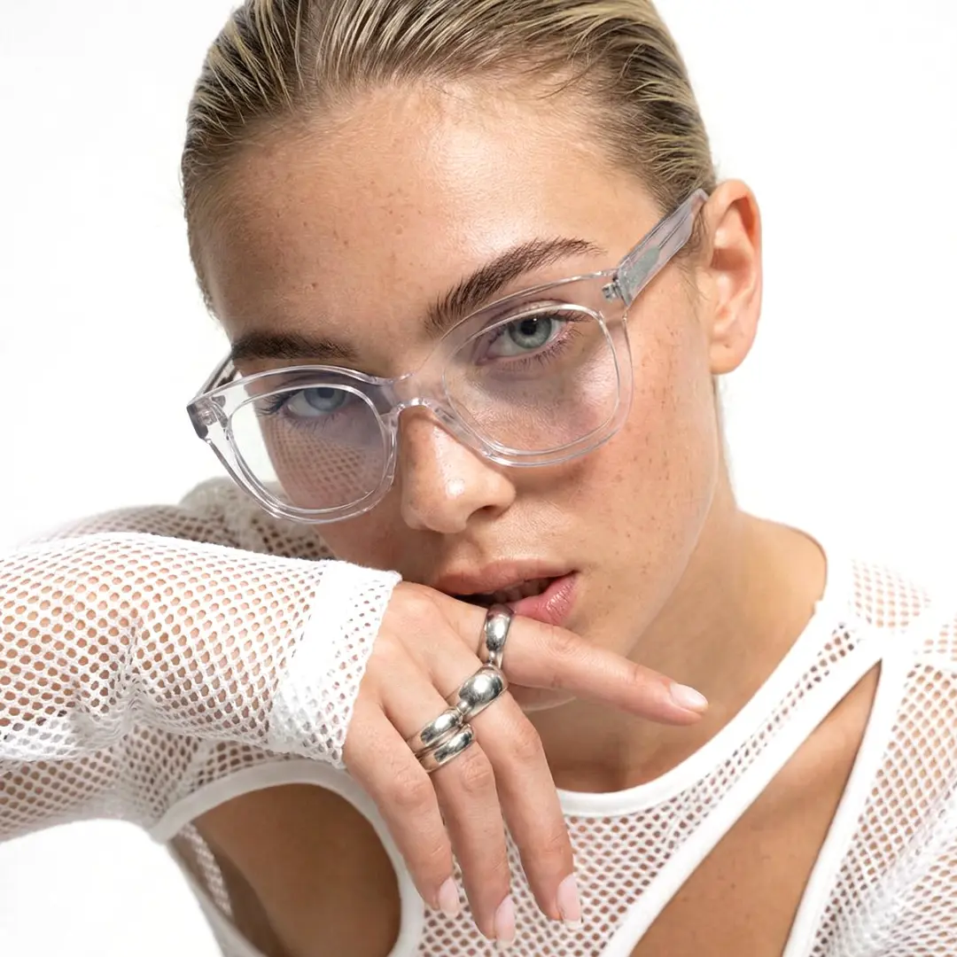 Face close-up view of female wearing clear cat eye eyeglasses, natural expression, CR0532505
