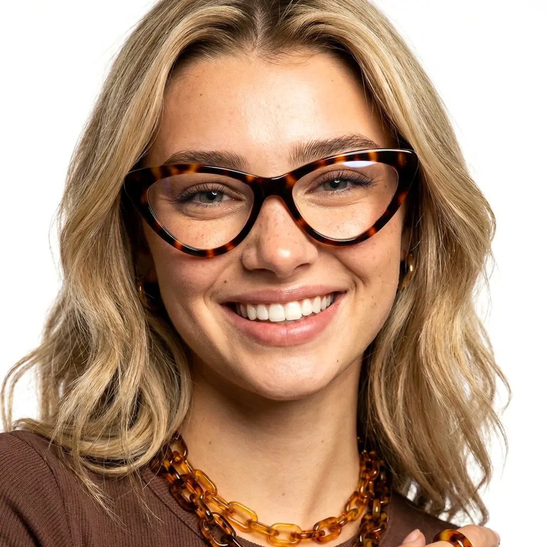 Front view of female wearing tortoise cat eye eyeglasses, smiling, CR0642302