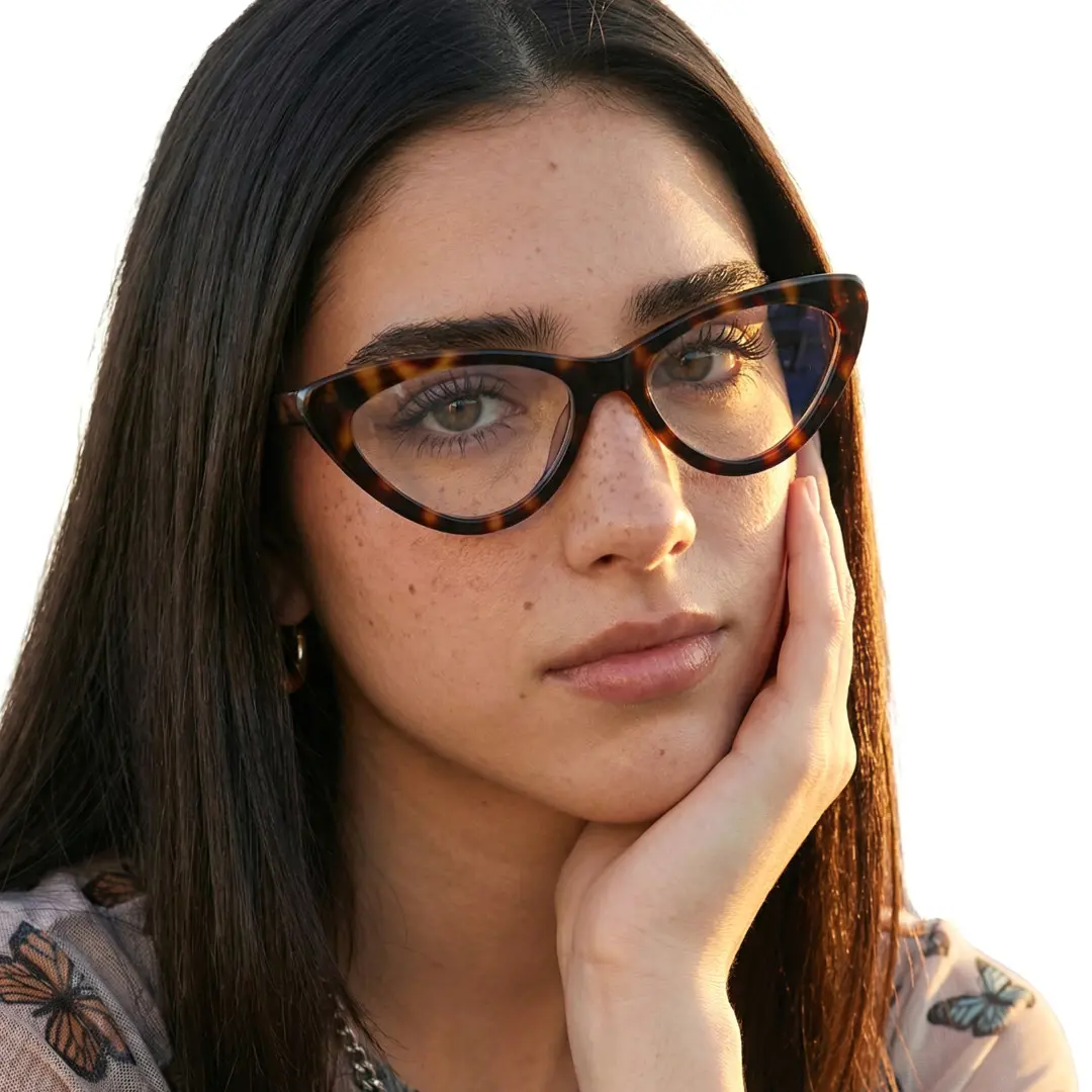 Three-quarter view of female wearing tortoise cat eye eyeglasses, resting chin on hand, natural expression, CR0642302