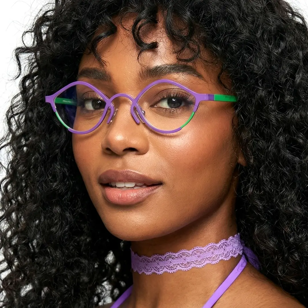 Portrait view of female wearing purple cat eye eyeglasses, natural smile, CT0062407