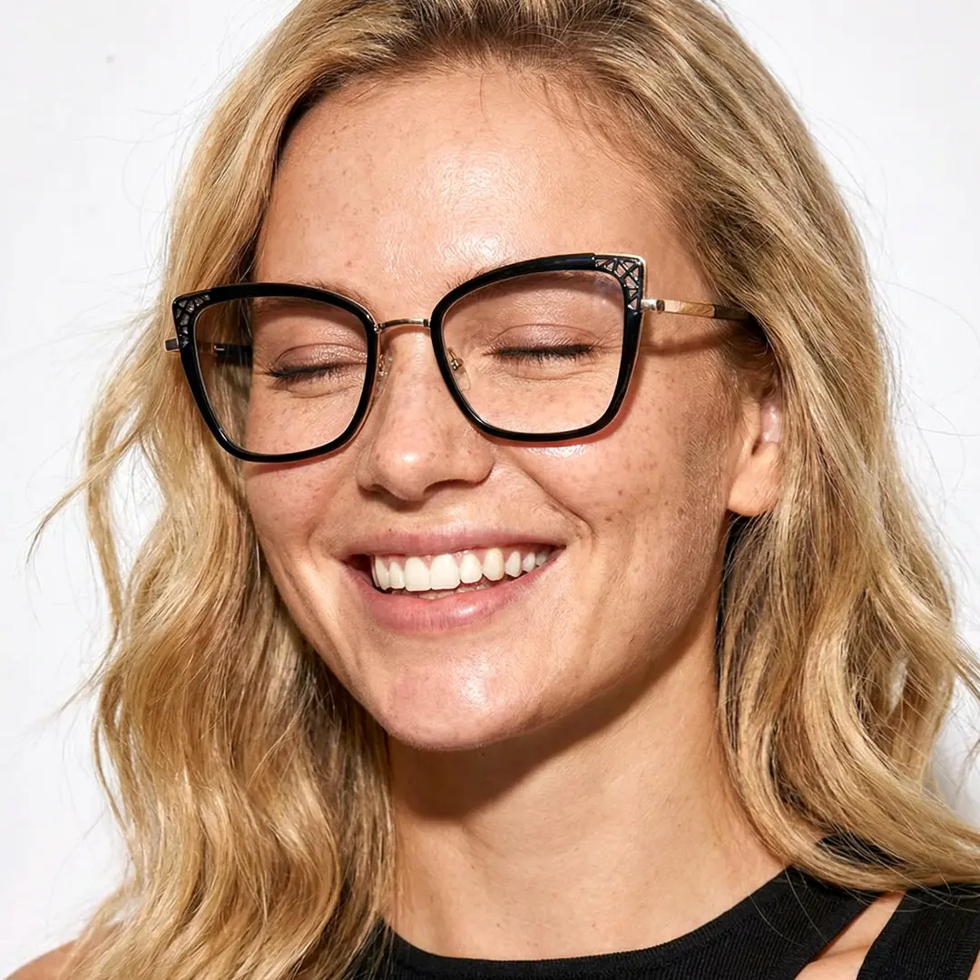 Close-up view of female wearing black cat eye eyeglasses, eyes slightly closed, CX0062510