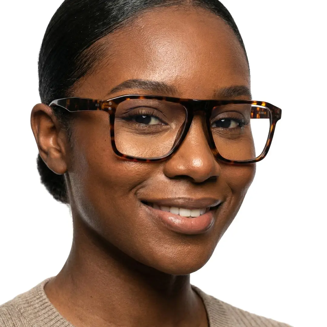 Slightly angled view of female wearing tortoise rectangle eyeglasses, natural smile, EA0012508