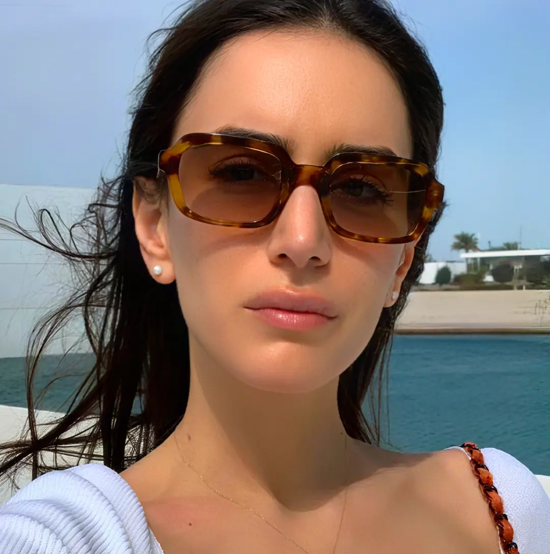 Front view of female wearing vintage tortoise rectangle eyeglasses, neutral expression, EA0022311