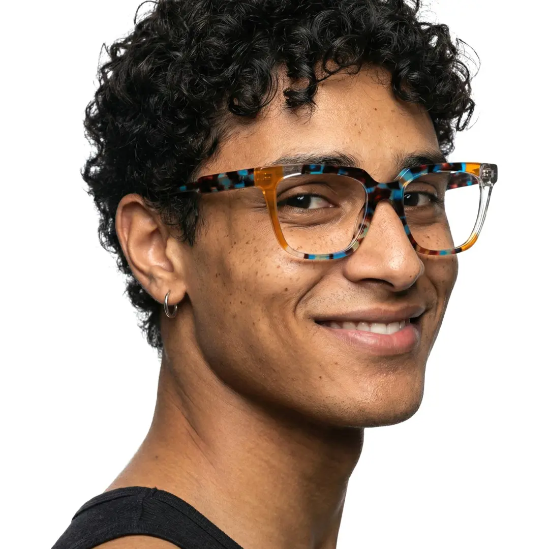 Over-the-shoulder view of male wearing colorful multicolor rectangle eyeglasses, friendly smile, EA0042209