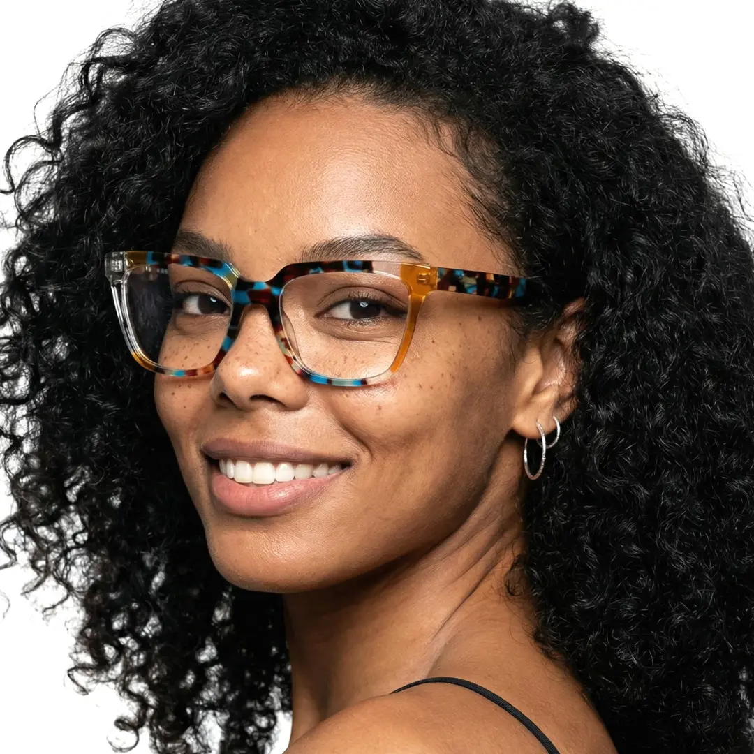 Profile view of female wearing colorful multicolor rectangle eyeglasses, smiling, EA0042209