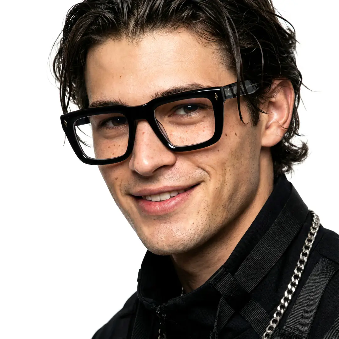 Face close-up view of male wearing black rectangle eyeglasses, soft smile, EA0062305