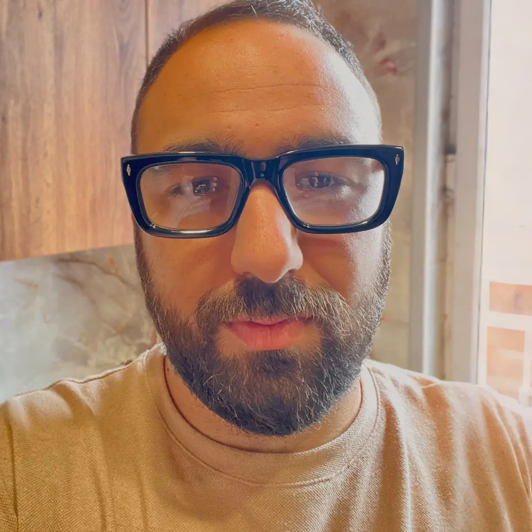 Looking straight ahead view of male wearing black rectangle eyeglasses, neutral expression, EA0062305