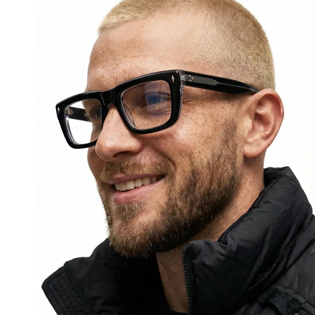 Three-quarter view of male wearing black rectangle eyeglasses, friendly smile, EA0062305