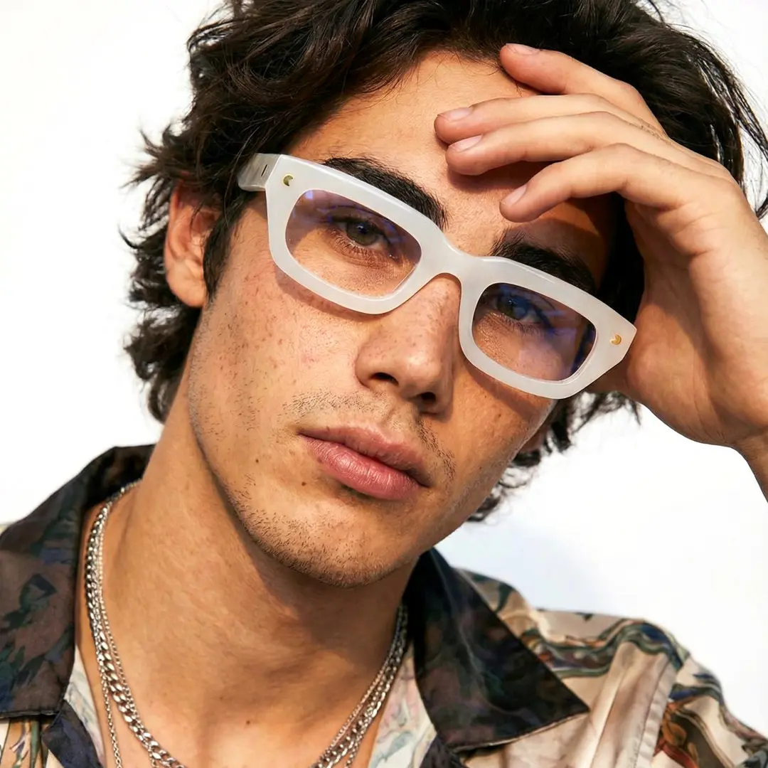 Looking straight ahead view of male wearing nerd white rectangle eyeglasses, hand resting on forehead, neutral expression, EA0072305