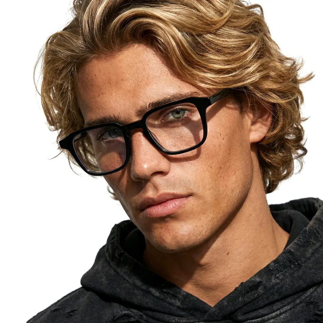 Front view of male wearing vintage black rectangle eyeglasses, tilting head, neutral expression, EA0122509