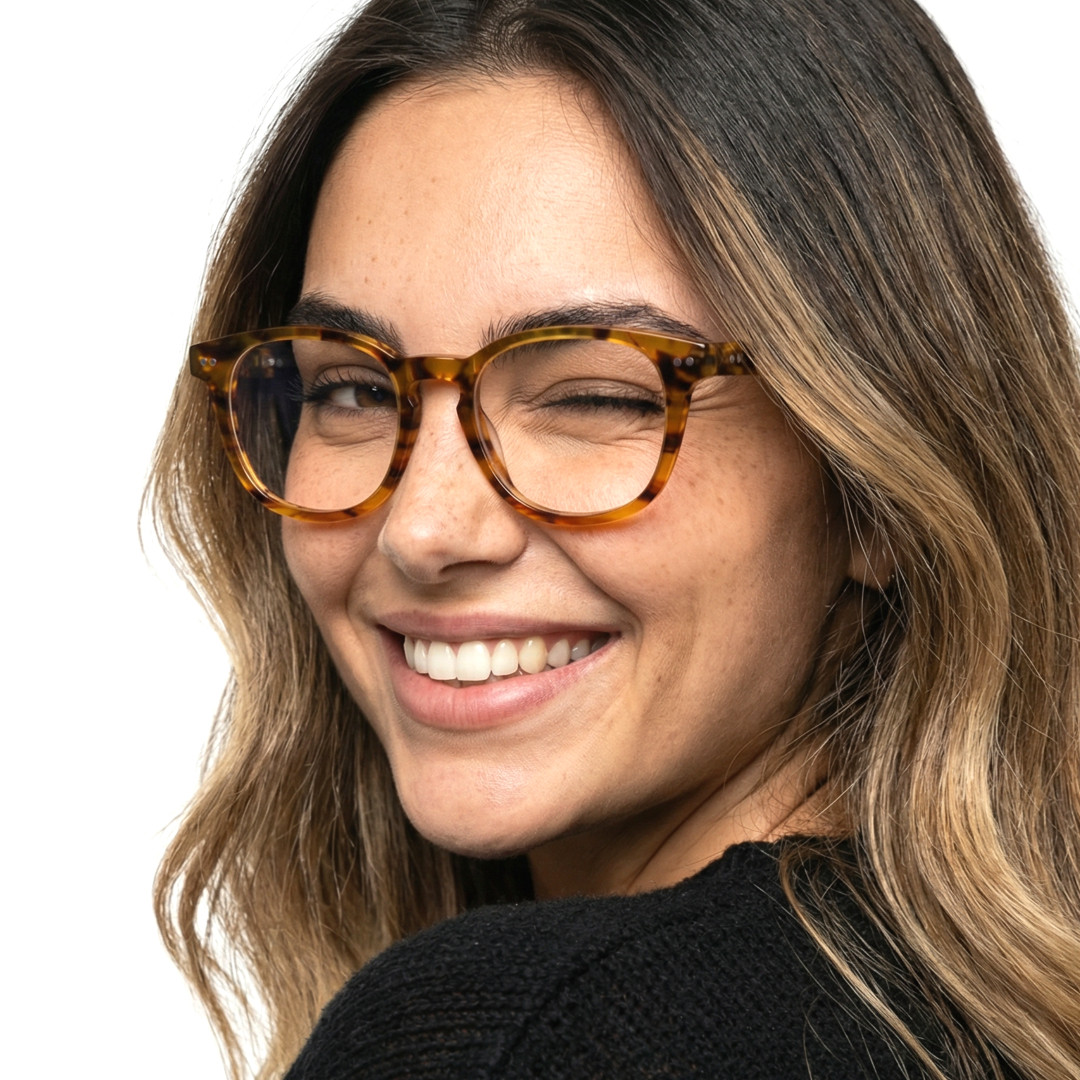 Over-the-shoulder view of female wearing colorful tortoise rectangle eyeglasses, winking, smiling, EA0142209