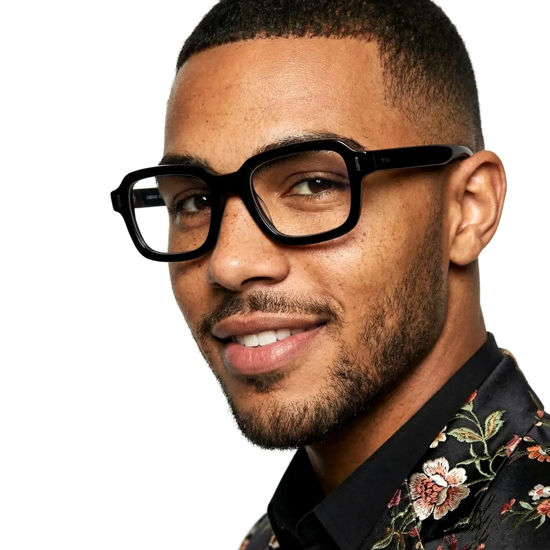 Profile view of male wearing y2k black rectangle eyeglasses, smiling, EA0412508