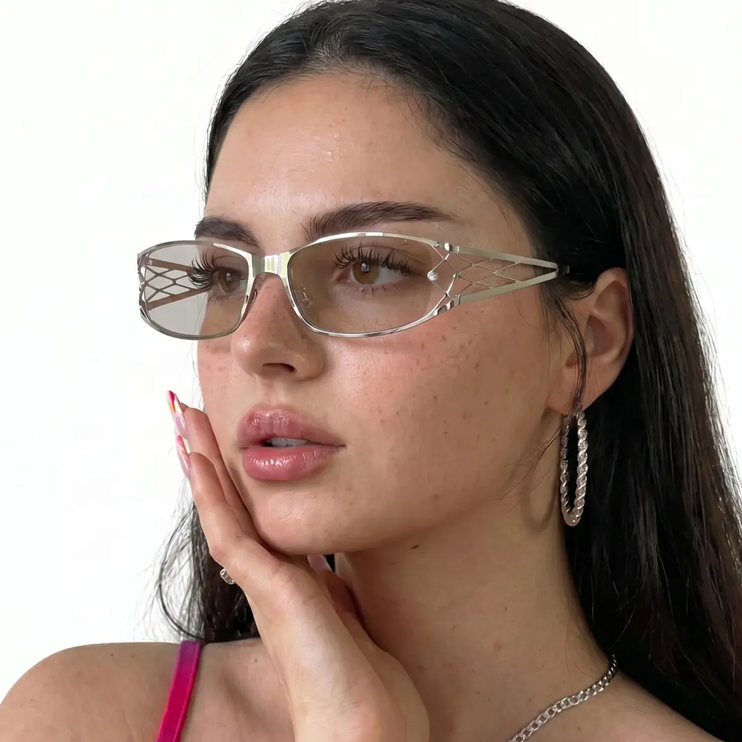 Three-quarter view of female wearing y2k silver rectangle sunglasses, hand near face, natural expression, EM0032604