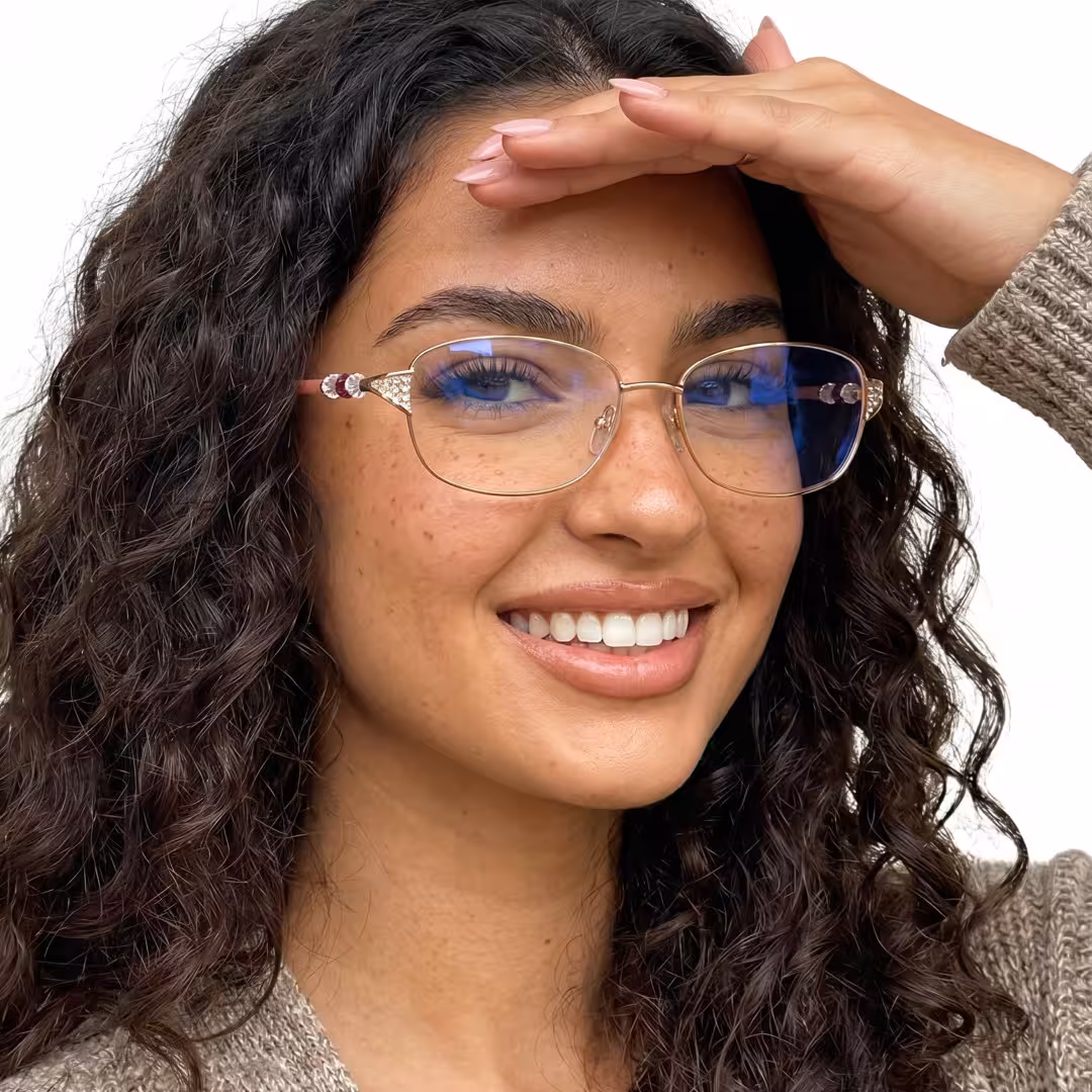 Female wearing gold rectangle metal eyeglasses, smiling. SPU: EM0212605